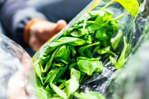 holding bagged spinach