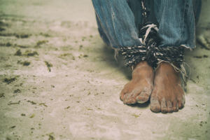 feet tied up on sandy ground