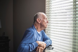 elderly man alone at window