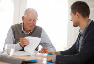 elderly man reading a contract