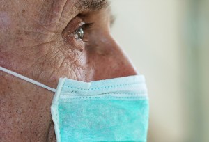 close-up of elderly man with protective face mask