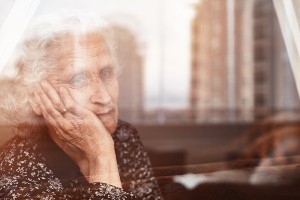 older woman looking out of window