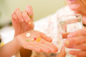 elderly patient taking pills