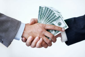 hands exchanging cash