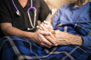 nurse holding elderly hands