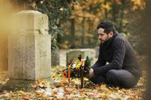 man visiting cemetary