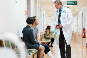 doctor talking to patient in hallway