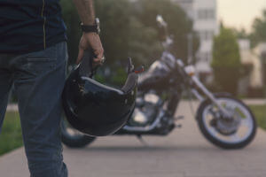 rider looking at his motorcycle
