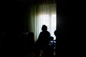 elderly woman in dark room