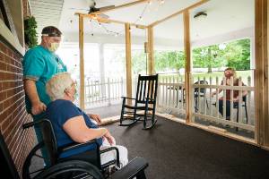 nursing home resident talking to visitor outside