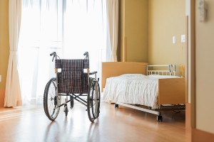 empty wheelchair in nursing home room
