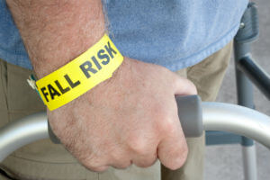 elderly man with walker and fall risk bracelet