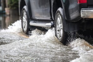 wheels of a car driving through deep water