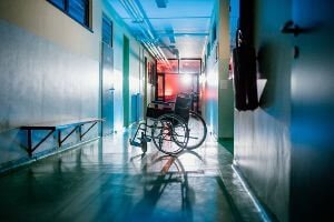 empty wheelchair in hallway of nursing home