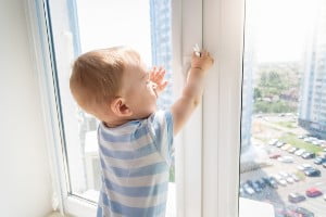 little boy unlocking window
