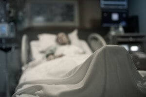 elderly woman lying in hospital bed