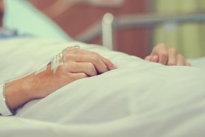 hand of patient in hospital bed