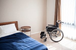 bed and wheelchair in room