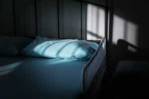bed with railing at nursing home