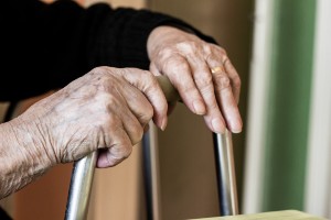 old person holding onto chair