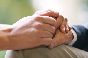 holding hands with an elderly person