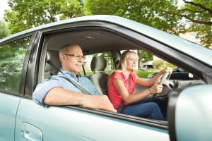 father teaching daughter to drive