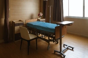 An empty nursing home bed.