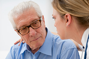 nurse talking to elderly man